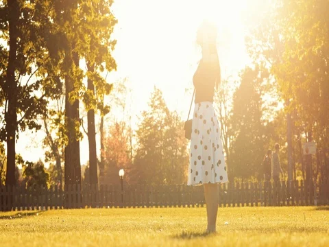 Young Couple Meeting in the Park, Hug and Kiss at Sunset. 4K DCi SLOW MOTION. Stock Footage