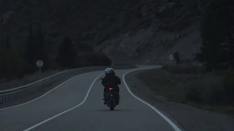 Young Couple of Motorcyclists are Riding a Bike on a Road in the Evening Light. Stock Footage