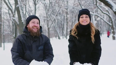 A young couple moves into the winter forest, throws snow up Stockbeeldmateriaal 65894277