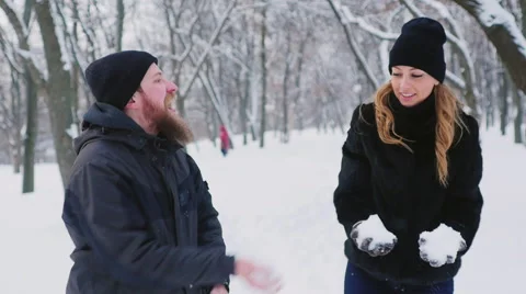 A young couple moves into the winter forest, throws snow up Stock Footage 65895680