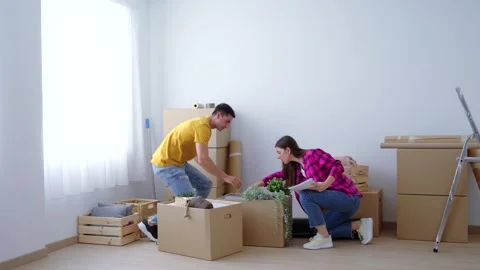 Young couple moving and transporting boxes Stock Footage 244640865