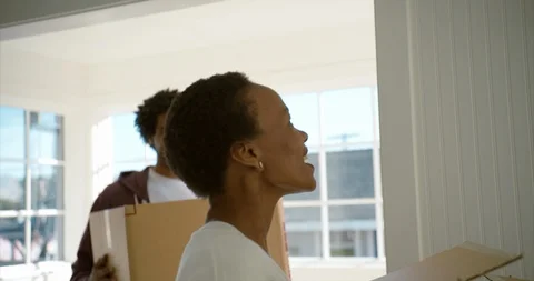 Young couple moving boxes into their new home. Stock-Footage 88373664