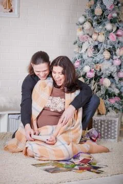 Young couple near a Christmas tree Stock Photos