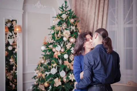 Young couple near a Christmas tree Stock Photos