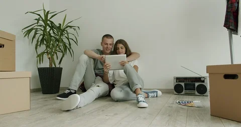 Young couple in new flat using tablet. Stock Footage 127294898