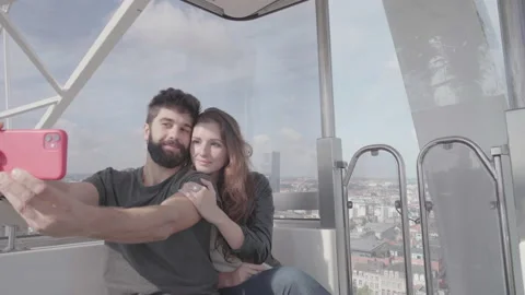 Young couple no ferris wheel, taking selfie and skyline pictures of Brussels Stock Footage 161757751