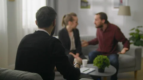 Young couple in the office of psychoanalyst. Fight between man and woman Stock Footage 123647209