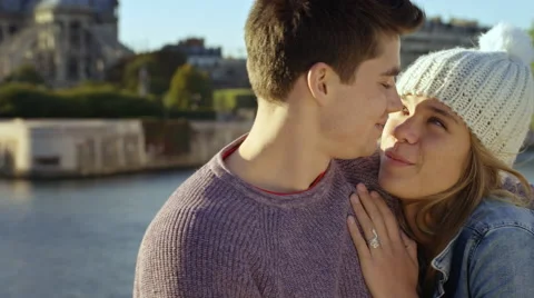 Young couple in Paris. Visiting Notre dame, Camera pans from Iconic landmark to Stock Footage 63029111