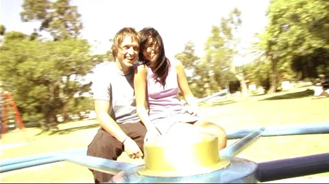 Young couple in park on roundabout Video stock 43683564