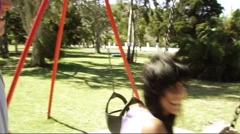 Young couple in park on swing Stock Footage 43683629