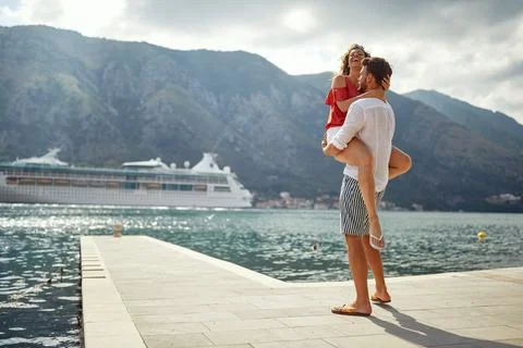 A young couple in a passionate hug while spending holiday on the seaside. L.. Stock Photos