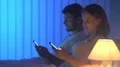 The young couple phone on the bed. night time 4k or 4k+ Resolution