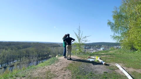 A young couple on a picnic at the top of the mountain. Stock Footage 192000294