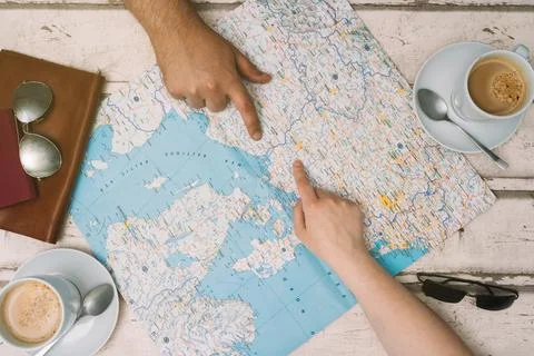 Young couple planning a trip with a map. Holidays, honeymoon. Top view. planning Stock Photos