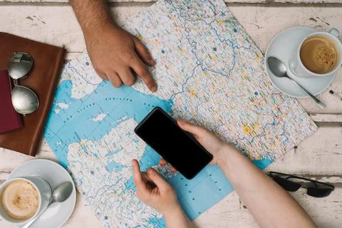 Young couple planning a trip with a map. Holidays, honeymoon. Top view. planning Stock Photos
