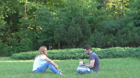 Young couple playing cards in the park 스톡 동영상 24690925