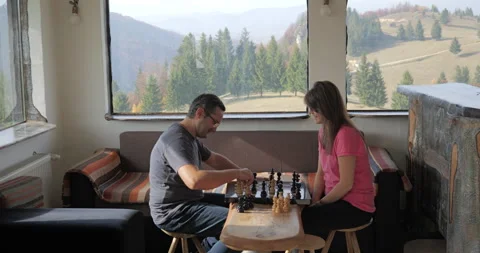 Young couple playing chess in a mountain rustic chalet Stock Footage 299020927