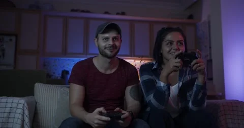 Young couple playing game with console at home 動画素材 141871020