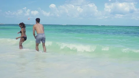 Young Couple Playing in the Ocean Waves, Tropical Beach Stock Footage 116628317