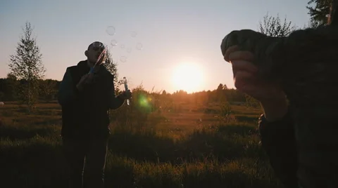 Young couple playing with soap bubbles Stock Footage 68461160