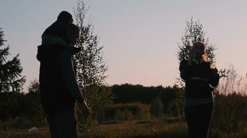 Young couple playing with soap bubbles on nature Stock Footage 68486977