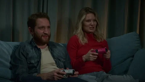 A young couple playing a video game console. Stock Footage 282443420