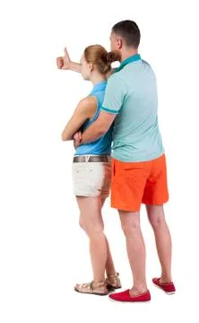 Young couple pointing at wal Back view Stock-Fotos