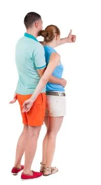 Young couple pointing at wal Back view Stock-Fotos