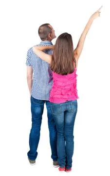 Young couple pointing at wal Back view Stock Photos