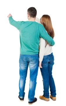 Young couple pointing at wal Back view Stock-Fotos