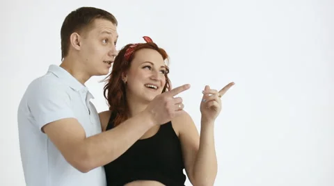 The young couple points out there. There is a place for your text. Stock Footage 61631239