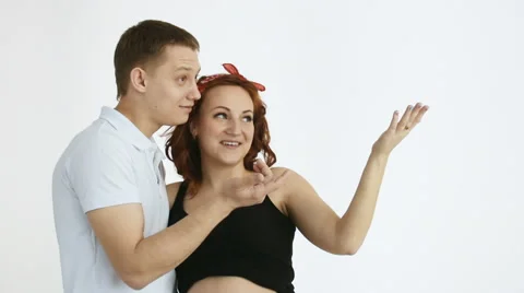 The young couple points out there. There is a place for your text. Video stock 61631266
