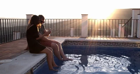 Young couple by pool at sunset Video stock 119025247