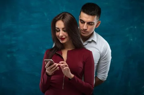 Young couple posing on blue background Stock Photos