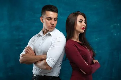 Young couple posing on blue background Stock Photos