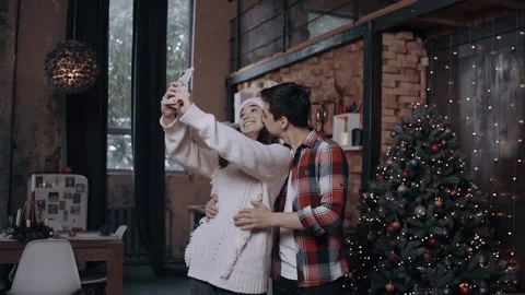 Young couple posing with the front camera of the phone while spending time at Stock Footage 143086535