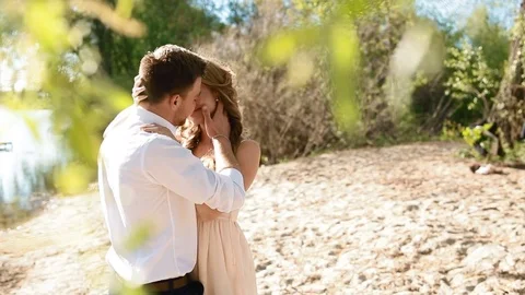 Young couple posing near the river Stock Footage 74076668