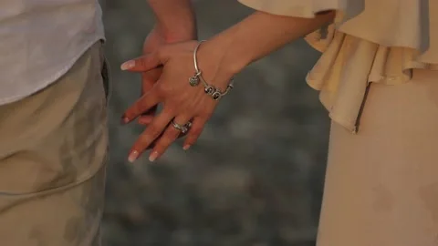 Young couple posing near the river. Bride and groom holding each other. Shot Stock Footage 142895210