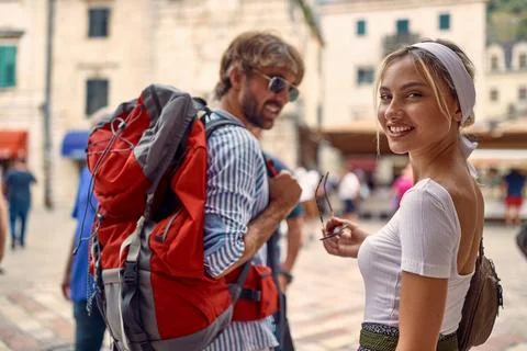 A young couple is posing for a photo while walking the old city during a ho.. Stock Photos