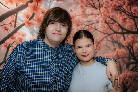 Young couple posing together in front of a beautiful cherry blossom backdro.. Stock Photos