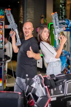 Young couple posing with a toy shotgun Stock-Fotos
