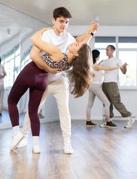 Young couple practicing passionate samba in dance class Fotos Stock