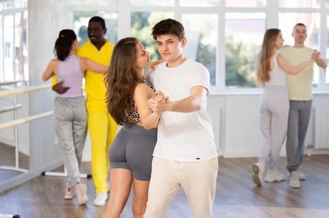 Young couple practicing passionate samba in dance class Stock Photos