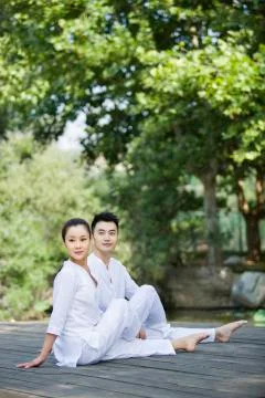 Young couple practicing yoga Stock Photos