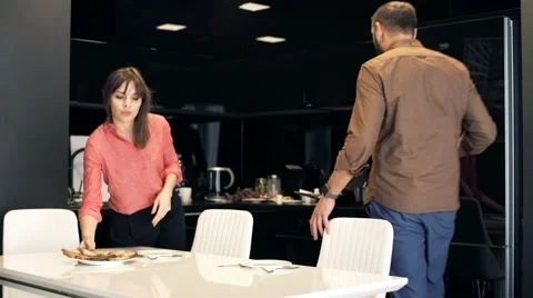 Young couple preparing breakfast by table at home Stock Footage 66764183