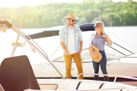 Young couple preparing on the dock is preparing to sail Stock Photos