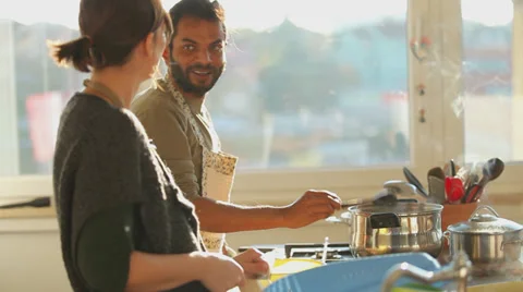 Young couple preparing lunch in the kitchen Stock Footage 35185389