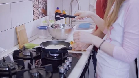 Young couple preparing their own breakfast in the kitchen. Stock Footage 77524372