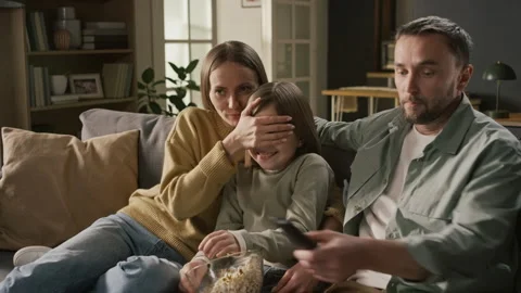 Young Couple Protecting Daughter from Explicit Content in Movie Stock Footage 331041527