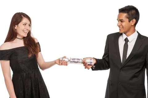 Young couple pulling a xmas cracker. Stock Photos
